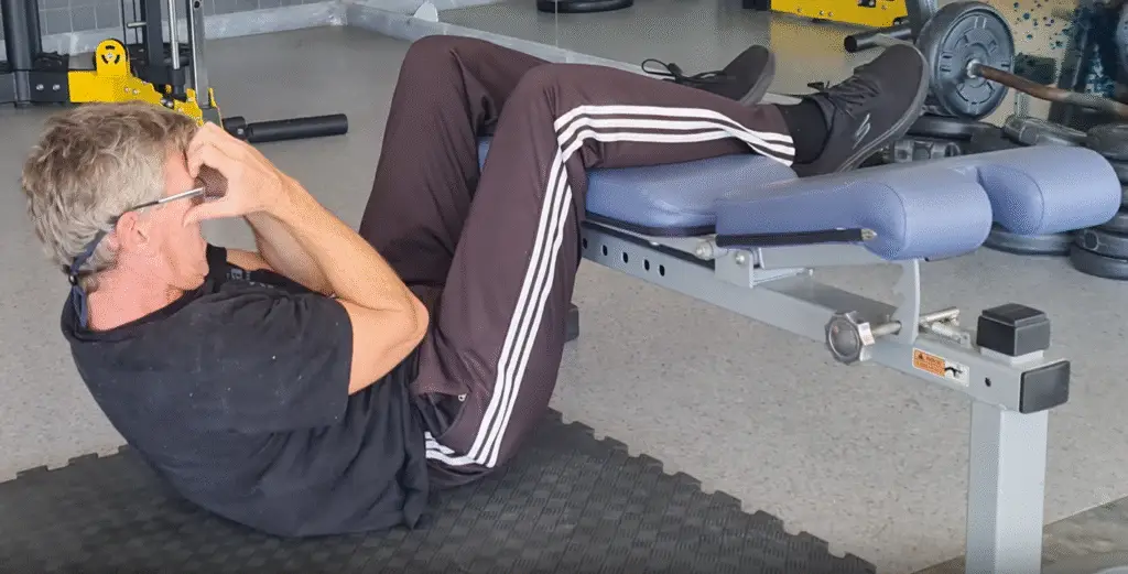 Showing a still from the Bench Crunch video - one of the bet abdominal exercises you can do