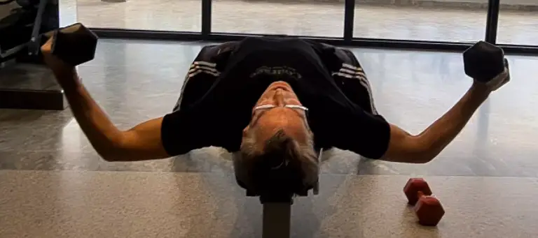 showing the Flat Bench Dumbbell Fly - a gym exercise where symmetry is crucial