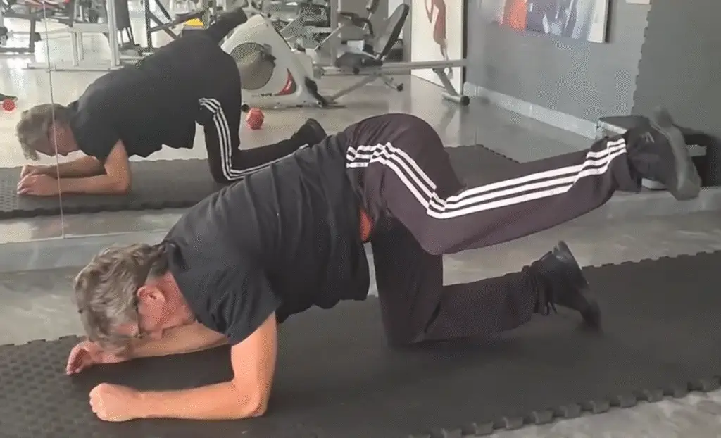 Showing the Fire Hydrant Pilates exercise - a still image from my fire Hydrant video