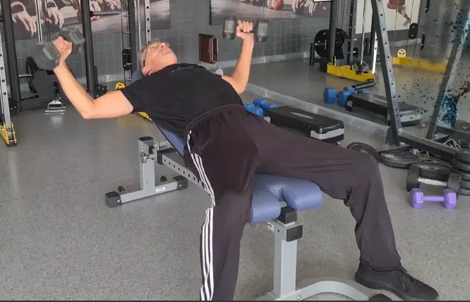 Showing a still image from the Incline Dumbbell Fly video - a gym exercise to build the Upper Chest Muscles