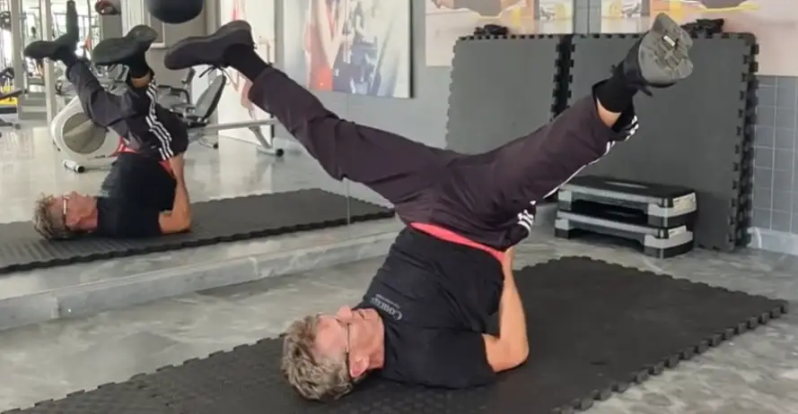 Showing the Legs Up Scissors Stretch exercise
