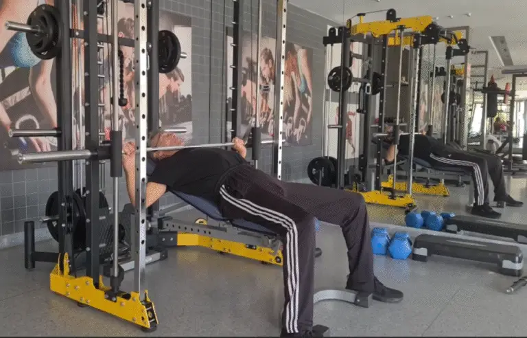 Showing a still image from the Smith Machine Press video, specifically the Incline Bench Press gym exercise for Upper Chest activation