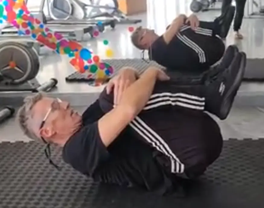 Showing the Double Knee Hug Pilates exercise