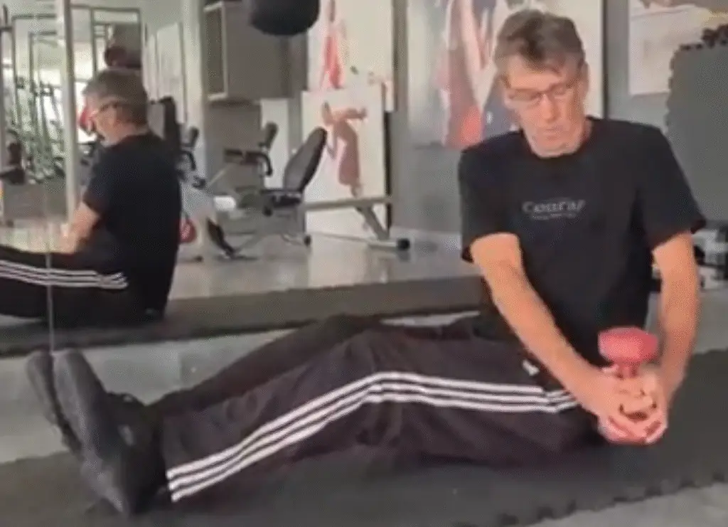 Shows a still image of the Russian Twist exercise from my videos giving Abs Pilates Lessons