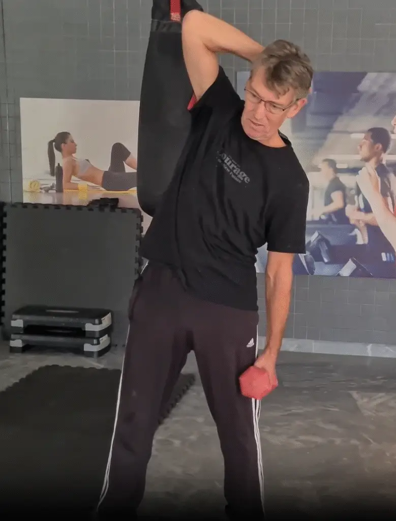 shows a still image from my Dumbbell Side bend video - limiting the Range of Motion and using muscle tension and engagement - can be used with the Cable Oblique Twist for working the Obliques