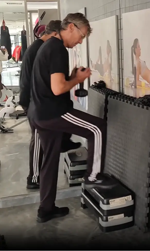 Shows a still image from my video on the Dumbbell steps exercise, which is a superb example of a Leg warm-up exercise